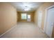 Carpeted living room with a door to the exterior and a ceiling fan at 2548 Gadsen Walk, Duluth, GA 30097