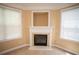 Cozy living room with a fireplace, large windows, and soft carpeting for a relaxing atmosphere at 2548 Gadsen Walk, Duluth, GA 30097