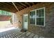 Covered patio with brick and a white door and window at 2548 Gadsen Walk, Duluth, GA 30097