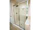 This shower features glass doors, tiled floors, and chrome shower head at 2548 Gadsen Walk, Duluth, GA 30097