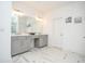 Bright bathroom featuring a double vanity with gray cabinets and white marble countertops at 2589 Cajun Dr, Marietta, GA 30066