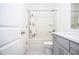 Bathroom with shower-tub combo, white tiled flooring and light grey vanity at 2589 Cajun Dr, Marietta, GA 30066
