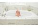 Close up of bathtub with marble tile surround and wooden bath caddy at 2589 Cajun Dr, Marietta, GA 30066