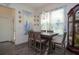 Cozy dining area with a wooden table, stylish chairs, a large window, and blue-patterned curtains at 2589 Cajun Dr, Marietta, GA 30066