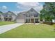 Charming two-story home with a manicured front lawn, a brick facade, and a two-car garage at 2589 Cajun Dr, Marietta, GA 30066