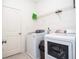 Bright laundry room includes a washer, dryer, and storage shelf at 2589 Cajun Dr, Marietta, GA 30066