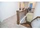 Carpeted staircase leading to a hardwood floor landing with iron spindles and wood railing at 2589 Cajun Dr, Marietta, GA 30066
