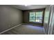 A bedroom with carpet flooring, a large window, and closet at 510 Ward Rd, Ellenwood, GA 30294