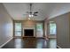 Cozy living room featuring hardwood floors, fireplace, and access to an outdoor patio at 510 Ward Rd, Ellenwood, GA 30294