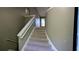 Carpeted stairway featuring a unique curved wall at 510 Ward Rd, Ellenwood, GA 30294