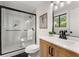 Bathroom featuring tiled shower with glass door and updated vanity at 3152 Normandy Ne Cir, Marietta, GA 30062