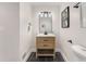 Elegant half-bathroom featuring a stylish vanity, modern lighting, and chic decor at 3152 Normandy Ne Cir, Marietta, GA 30062