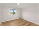 Bright bedroom with wood floor, fresh paint, and a window looking outside at 3152 Normandy Ne Cir, Marietta, GA 30062