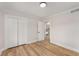 Bedroom featuring wood floor, white trim, closet, and a view into an adjacent room at 3152 Normandy Ne Cir, Marietta, GA 30062