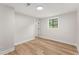 Bright bedroom with wood-look flooring and a window to the backyard at 3152 Normandy Ne Cir, Marietta, GA 30062