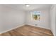A clean, empty bedroom with hardwood floors, a built-in closet, and a window for natural light at 3152 Normandy Ne Cir, Marietta, GA 30062