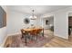 Chic dining area features modern light fixture and stylish rug on light-colored hardwood flooring at 3152 Normandy Ne Cir, Marietta, GA 30062