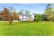 Bright two-story home with an open lawn, wooden front steps, and mature trees at 3152 Normandy Ne Cir, Marietta, GA 30062