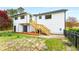 Back of home with a wooden stairway leading to a deck and yard at 3152 Normandy Ne Cir, Marietta, GA 30062
