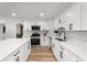 Well-lit kitchen with stainless steel appliances, an island, and white cabinetry at 3152 Normandy Ne Cir, Marietta, GA 30062