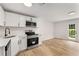 Kitchen featuring white cabinets, stainless appliances, and a rear exit at 3152 Normandy Ne Cir, Marietta, GA 30062
