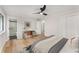 Spacious main bedroom with a fan, a modern accent table, fresh paint, and window at 3152 Normandy Ne Cir, Marietta, GA 30062