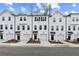 Beautiful townhomes featuring white exteriors, black accents, individual garages, and inviting curb appeal at 3170 Washburn Sw St, Atlanta, GA 30354