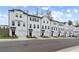 Attractive row of townhomes with white facades, dark roofs, garages, and well-maintained landscaping at 3170 Washburn Sw St, Atlanta, GA 30354