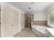 Bathroom features a walk-in shower, tub and a large mirror over the vanity at 550 Eldridge Dr, Suwanee, GA 30024