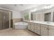 Bathroom features a large mirror, double vanity, walk-in shower and tub at 550 Eldridge Dr, Suwanee, GA 30024