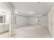 Spacious bedroom with neutral carpet, white walls, tray ceiling and light fixtures at 550 Eldridge Dr, Suwanee, GA 30024