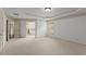 Spacious bedroom featuring neutral carpet, white walls, tray ceiling and light fixtures at 550 Eldridge Dr, Suwanee, GA 30024