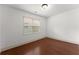 Empty bedroom with hardwood floors, a window, and neutral walls at 550 Eldridge Dr, Suwanee, GA 30024