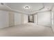 Spacious bedroom featuring neutral carpet, white walls, tray ceiling and two windows at 550 Eldridge Dr, Suwanee, GA 30024