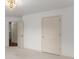 Neutral bedroom features a decorative chandelier, plush carpet, and white walls at 550 Eldridge Dr, Suwanee, GA 30024