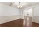 Elegant dining area featuring hardwood floors, a coffered ceiling, and wainscoting at 550 Eldridge Dr, Suwanee, GA 30024