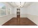 Elegant dining room with coffered ceiling, wainscoting, and view into kitchen at 550 Eldridge Dr, Suwanee, GA 30024