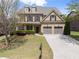 Beautiful brick home featuring a manicured lawn and a two-car garage in a suburban neighborhood at 550 Eldridge Dr, Suwanee, GA 30024