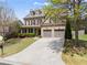 Charming two-story brick home with a well-maintained lawn, driveway, and attached two-car garage at 550 Eldridge Dr, Suwanee, GA 30024