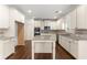 Bright kitchen featuring stainless steel appliances, granite countertops, and white cabinetry at 550 Eldridge Dr, Suwanee, GA 30024