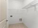 Bright laundry room featuring wire shelving, ample outlets, and tile flooring at 550 Eldridge Dr, Suwanee, GA 30024