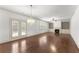 Open living room with hardwood floors, fireplace, and French doors at 550 Eldridge Dr, Suwanee, GA 30024