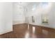 Spacious living area featuring hardwood floors and ample natural light from shuttered windows at 550 Eldridge Dr, Suwanee, GA 30024