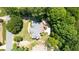 Aerial view of a house showcasing its layout, including a deck and surrounding greenery with nearby streets at 3465 Summit Trl, Cumming, GA 30041