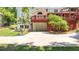 Spacious backyard features a driveway, basketball hoop, and lush greenery, perfect for outdoor activities at 3465 Summit Trl, Cumming, GA 30041