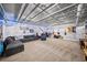 Finished basement featuring an open ceiling, modern flooring, and a comfortable seating area with ample space at 3465 Summit Trl, Cumming, GA 30041