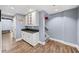 Basement area with modern flooring, a built-in bar area, and a staircase leading to another level at 3465 Summit Trl, Cumming, GA 30041