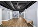 Finished basement featuring an open ceiling, stylish flooring, and a comfortable seating area with a bench at 3465 Summit Trl, Cumming, GA 30041