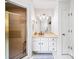 Well-lit bathroom features a vanity with storage, shower with tile surround, and neutral color palette at 3465 Summit Trl, Cumming, GA 30041