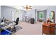 Spacious bedroom with a large window, ceiling fan, desk area, and ample space for furniture at 3465 Summit Trl, Cumming, GA 30041